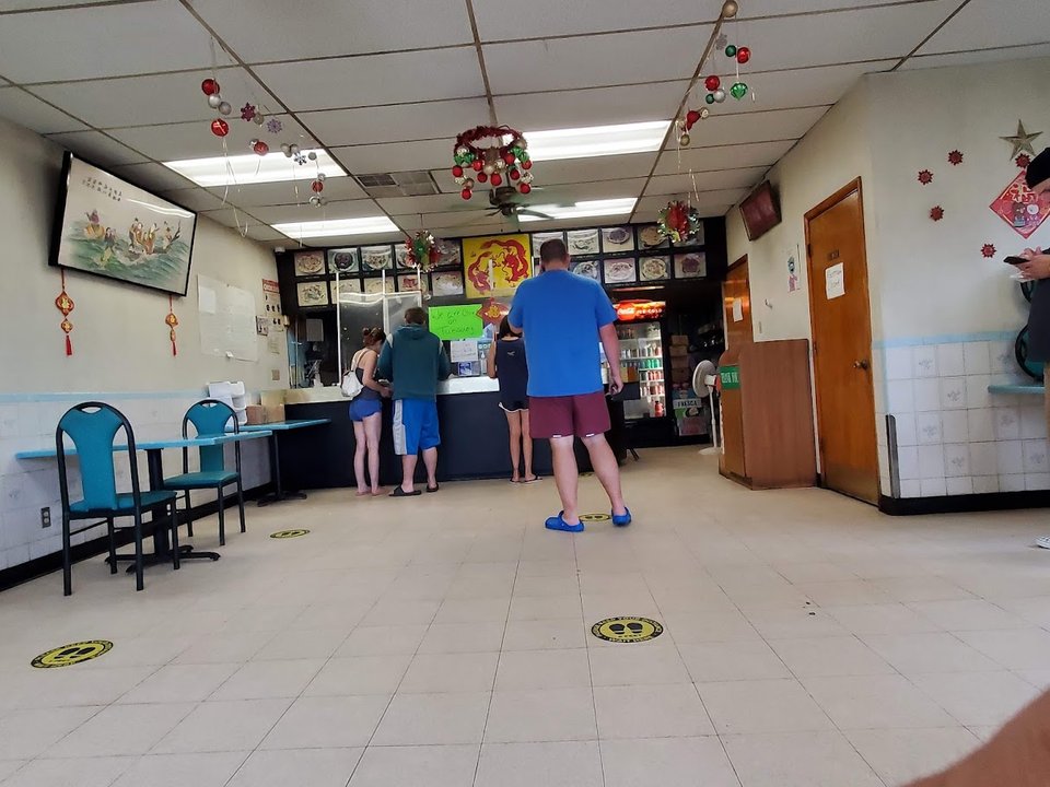 A restaurant table with covered takeout boxes.
